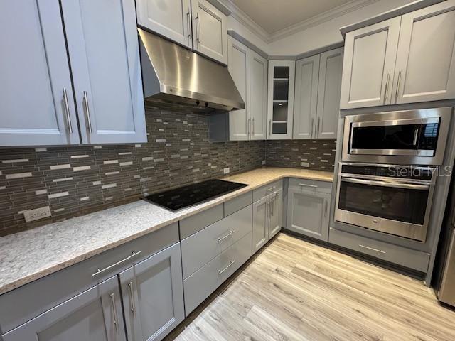 1515 Resolute Street Celebration, FL 34747 - Photo 8 of 39 a kitchen with granite countertop a sink stainless steel appliances and cabinets