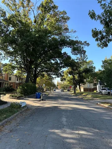 a view of a swimming pool and trees in the background