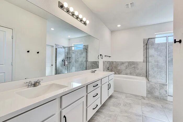 10403 Bramble Berry Drive Austin, TX 78748 - Photo 12 of 21 a spacious bathroom with a double vanity sink mirror and bathtub
