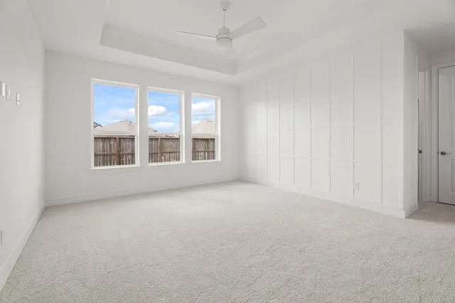 a kitchen with cabinets and chairs
