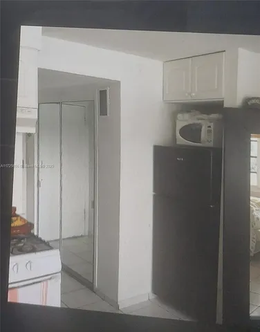 a kitchen with a refrigerator and cabinets