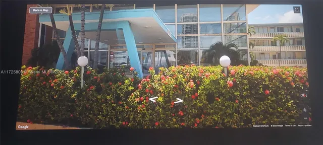 a front view of a house with a yard and garden