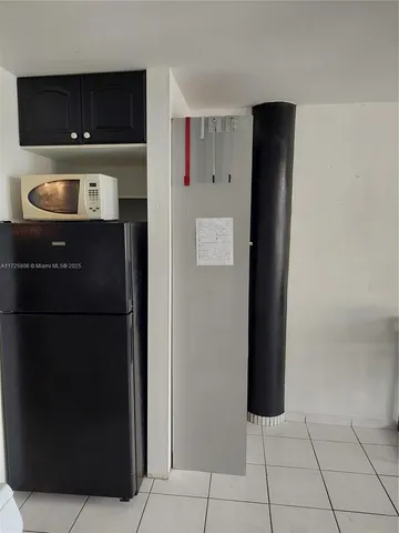 a room with a refrigerator and a sink