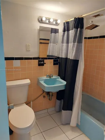 a bathroom with a toilet a sink and a mirror