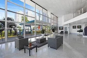 a living room with furniture and a large window