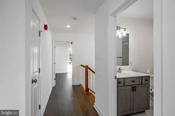 a view of hallway with wooden floor