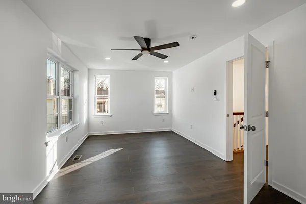 a bathroom with a shower sink vanity mirror and toilet