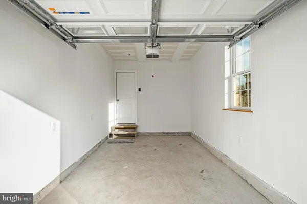 a view of a white house with a big yard and large tree