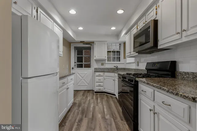 a kitchen with stainless steel appliances a refrigerator stove microwave and cabinets