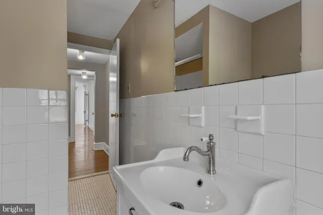 a bathroom with a sink and mirror