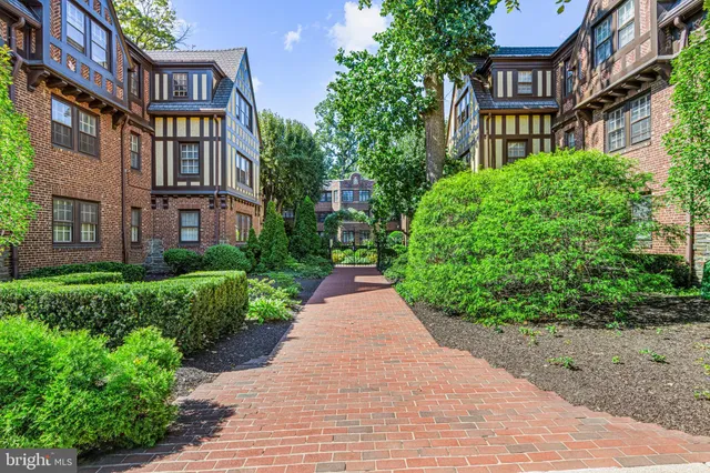 a view of a brick building next to a yard