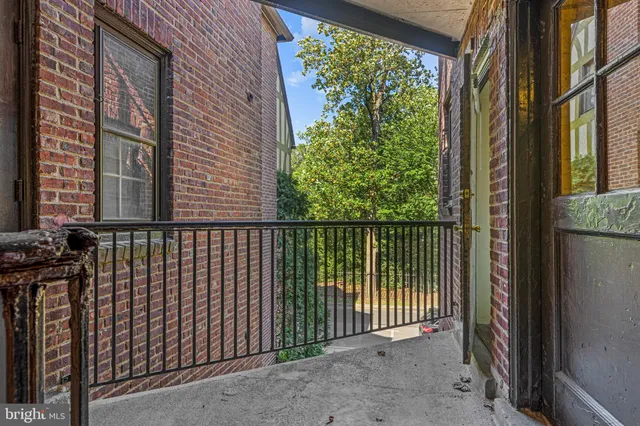 a side view of a house with a street