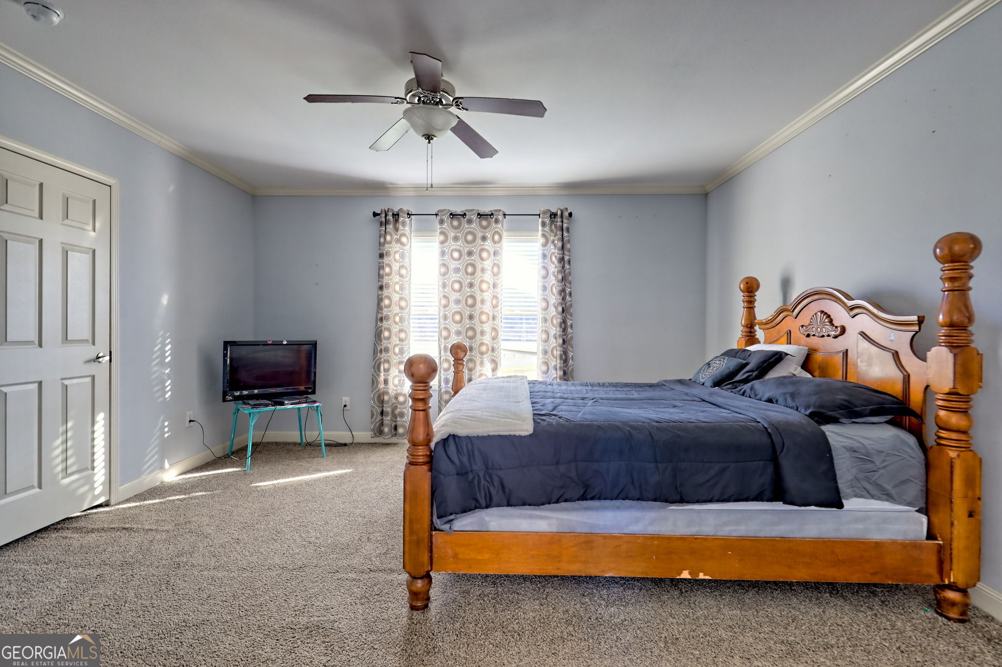 42 Jones Creek Road Blairsville, GA 30512 - Photo 27 of 56 a bedroom with a bed and a chandelier