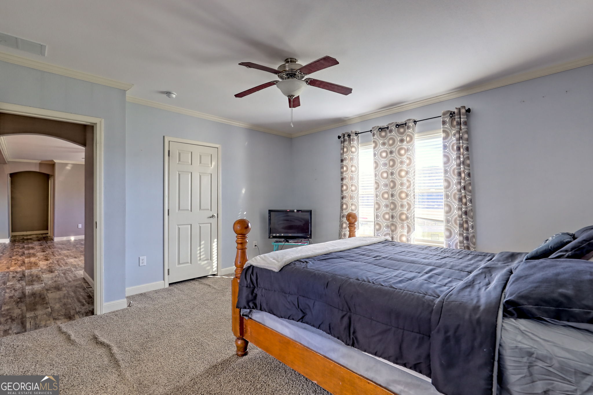 42 Jones Creek Road Blairsville, GA 30512 - Photo 36 of 56 a bedroom with a large bed and a chandelier