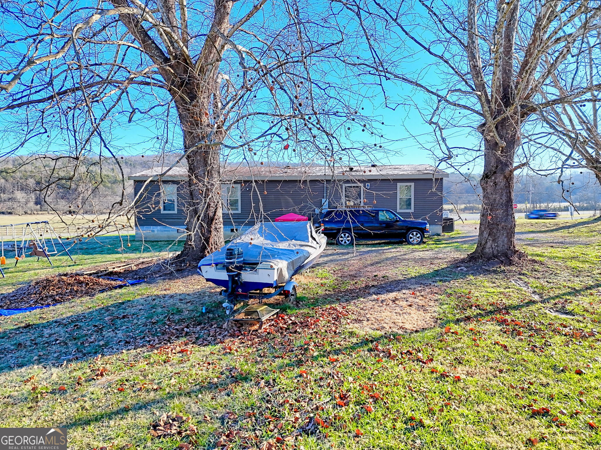 42 Jones Creek Road Blairsville, GA 30512 - Photo 8 of 56 a view of a backyard with table and chairs under a large tree