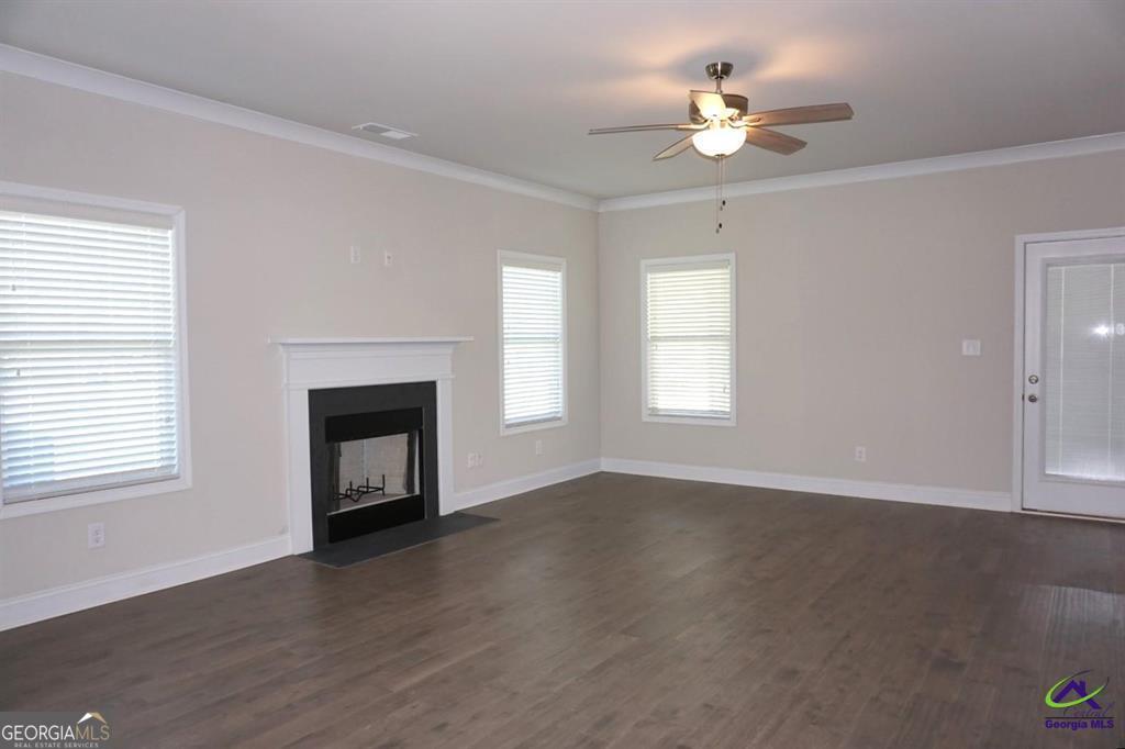 121 Bluecoat Trail Byron, GA 31008 - Photo 35 of 45 an empty room with windows and fireplace