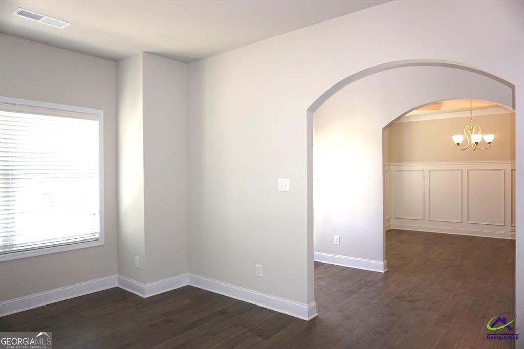 121 Bluecoat Trail Byron, GA 31008 - Photo 42 of 45 an empty room with wooden floor and windows