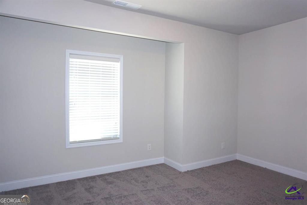 121 Bluecoat Trail Byron, GA 31008 - Photo 10 of 45 an empty room with a window