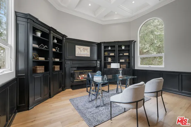 a living room with furniture or wooden floor and a large window