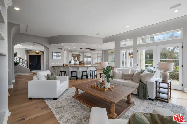 a kitchen with a dining table chairs and wooden floor