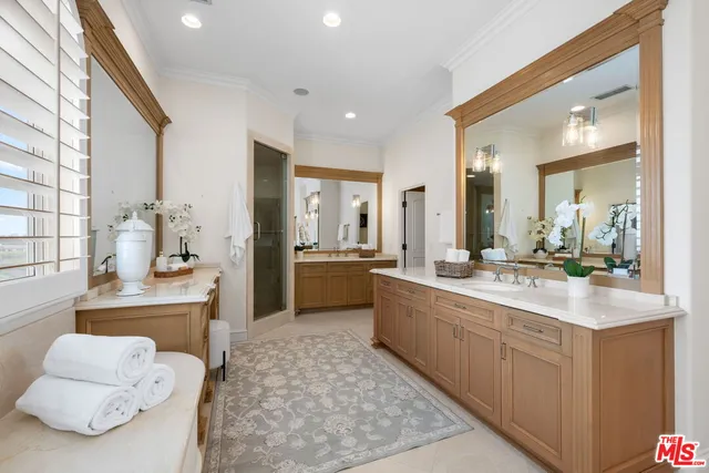 a bathroom with a granite countertop sink a toilet and shower
