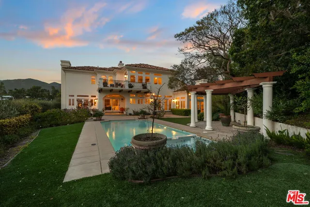 a front view of a house with a yard table and chairs