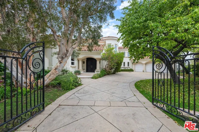 a view of a street sign under a large tree