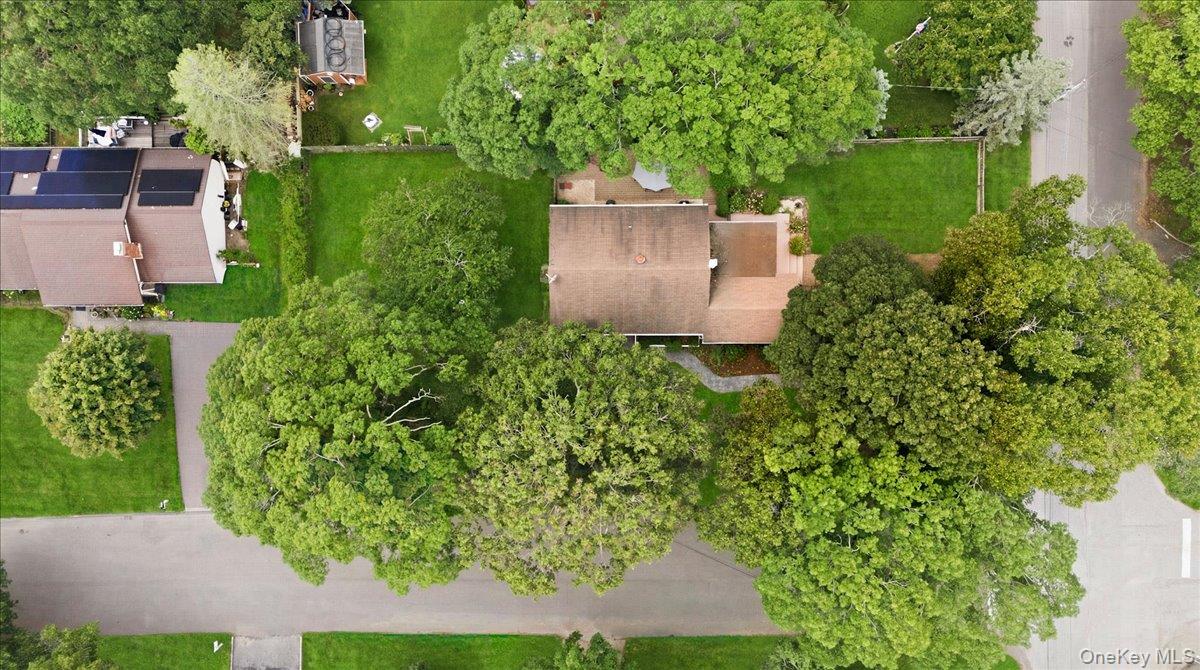 10 Graham Road Hampton Bays, NY 11946 - Photo 6 of 26 an aerial view of a house with a yard and a large tree