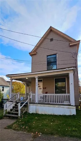 a view of a house with a yard and deck