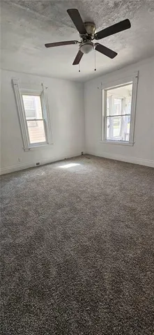 a view of a livingroom with a ceiling fan and window