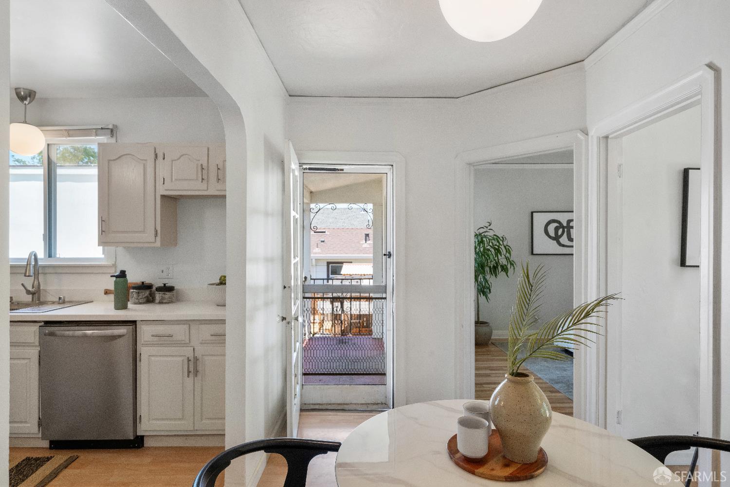 1475 Stannage Avenue Berkeley, CA 94702 - Photo 19 of 59 a kitchen with stainless steel appliances kitchen island granite countertop a refrigerator a sink a stove and white cabinets