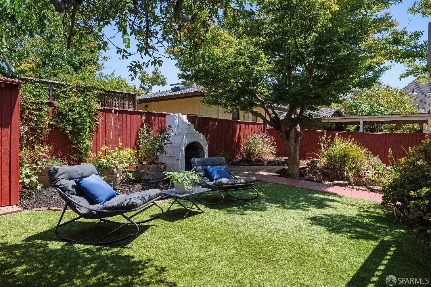 1475 Stannage Avenue Berkeley, CA 94702 - Photo 47 of 59 a view of a chair and table in the garden in front of house