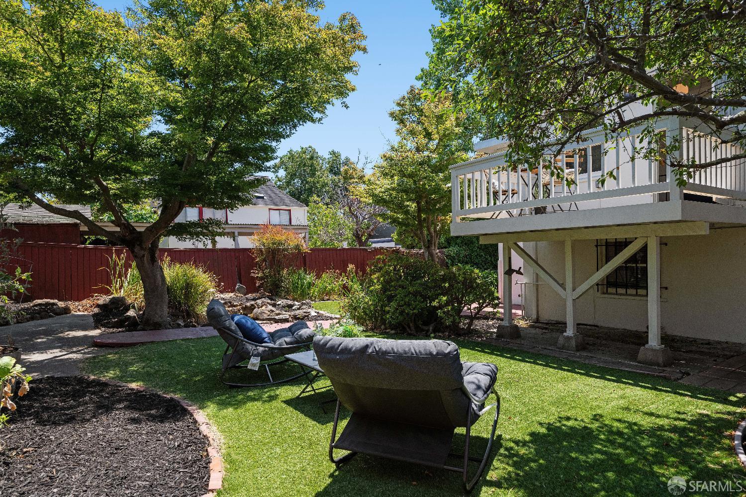 1475 Stannage Avenue Berkeley, CA 94702 - Photo 49 of 59 an outdoor sitting area with couch and wooden fence