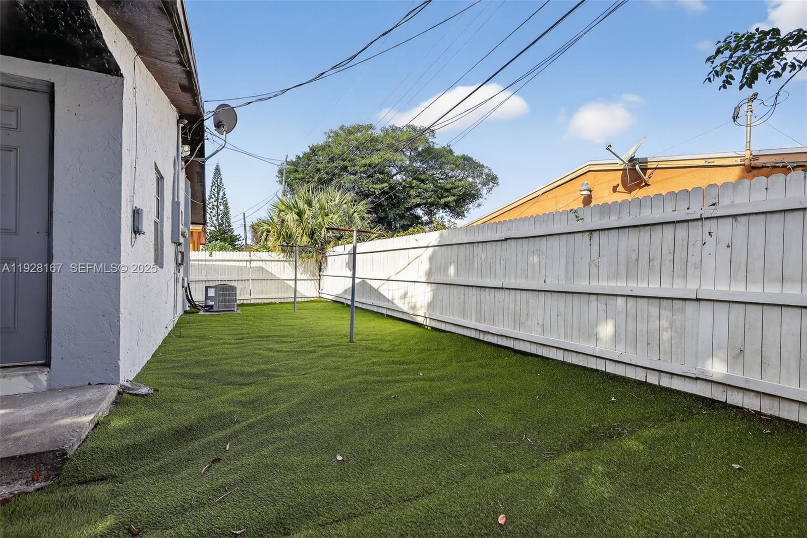 708 Southwest 10th Street, Unit 1 Dania Beach, FL 33004 - Photo 20 of 23 a backyard with a table and chairs