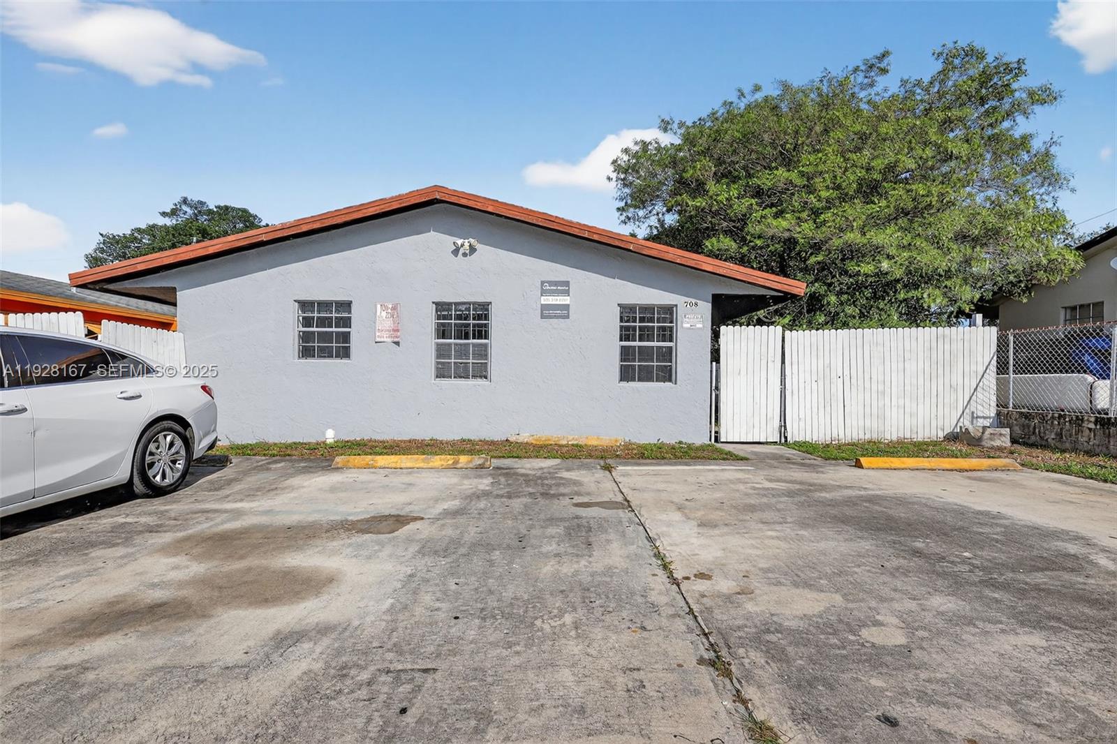 708 Southwest 10th Street, Unit 1 Dania Beach, FL 33004 - Photo 23 of 23 a view of a house with a patio and a yard