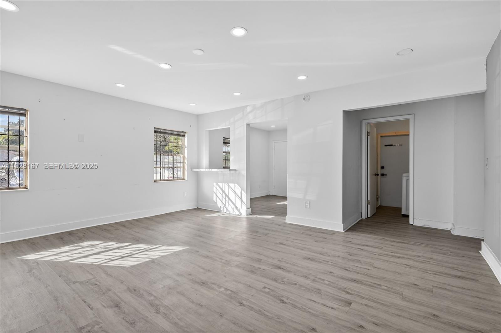 708 Southwest 10th Street, Unit 1 Dania Beach, FL 33004 - Photo 4 of 23 a view of empty room with wooden floor and window