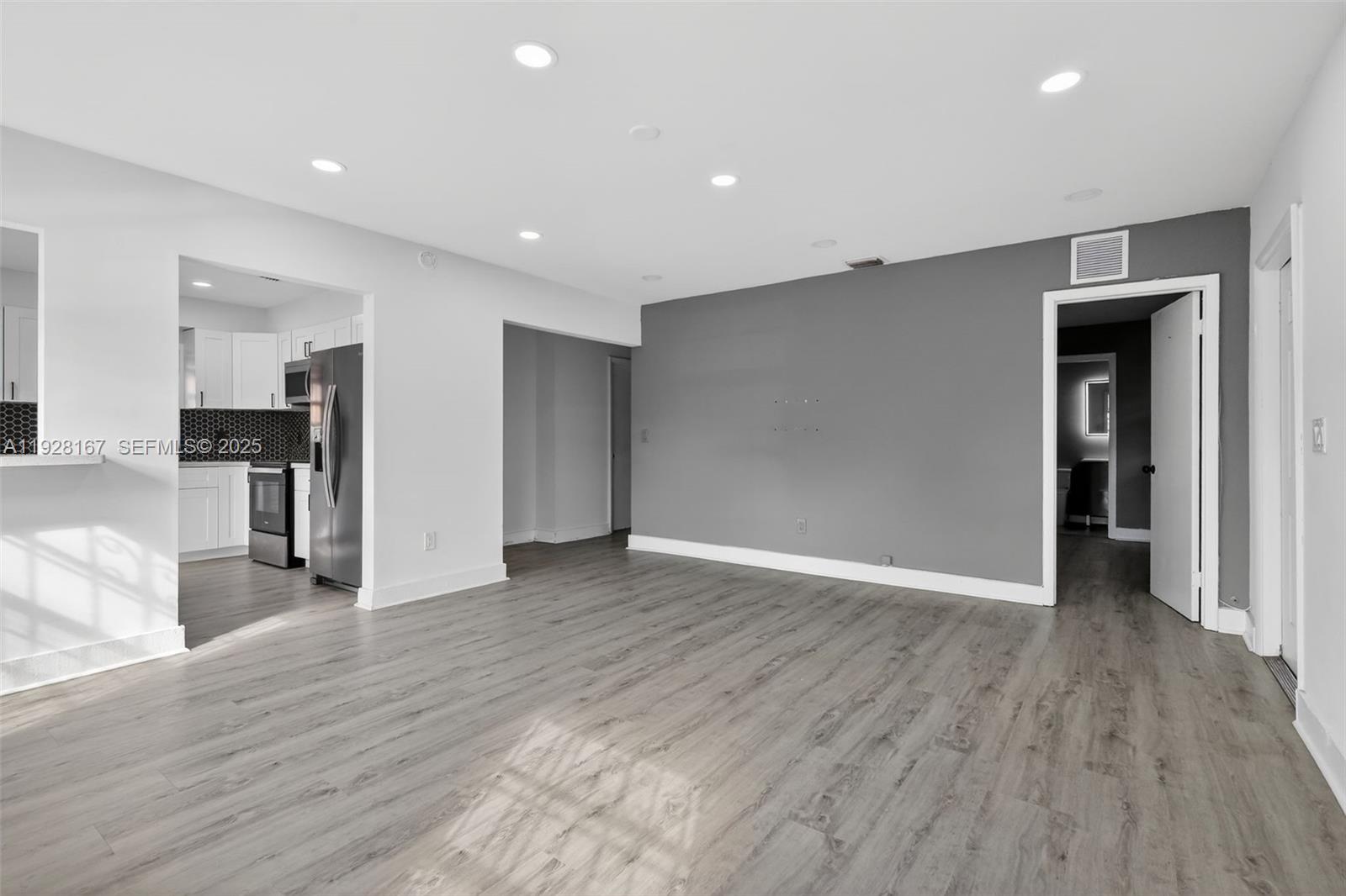 708 Southwest 10th Street, Unit 1 Dania Beach, FL 33004 - Photo 7 of 23 a view of empty room with wooden floor