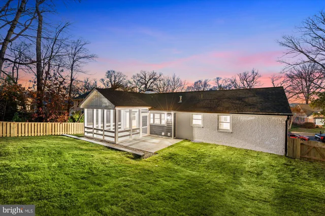 a view of a house with a yard balcony and sitting area
