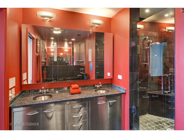 910 South Michigan Avenue, Unit 1101 Chicago, IL 60605 - Photo 13 of 20 a bathroom with a sink vanity and a mirror