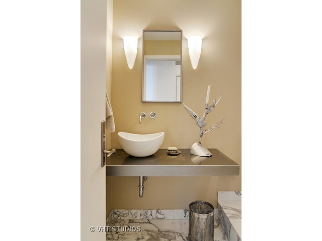 910 South Michigan Avenue, Unit 1101 Chicago, IL 60605 - Photo 15 of 20 a bathroom with a sink and mirror