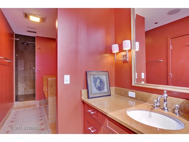 910 South Michigan Avenue, Unit 1101 Chicago, IL 60605 - Photo 16 of 20 a bathroom with a sink and a mirror