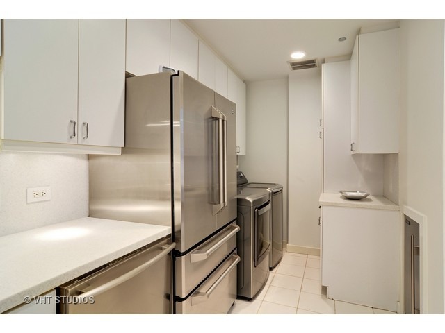 910 South Michigan Avenue, Unit 1101 Chicago, IL 60605 - Photo 19 of 20 a kitchen with a refrigerator and a sink