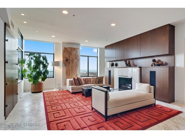 910 South Michigan Avenue, Unit 1101 Chicago, IL 60605 - Photo 3 of 20 a living room with furniture and a fireplace