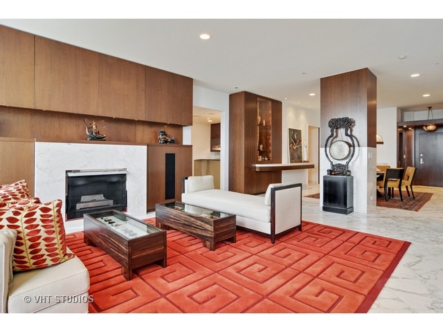 910 South Michigan Avenue, Unit 1101 Chicago, IL 60605 - Photo 4 of 20 a living room with furniture a flat screen tv and a fireplace