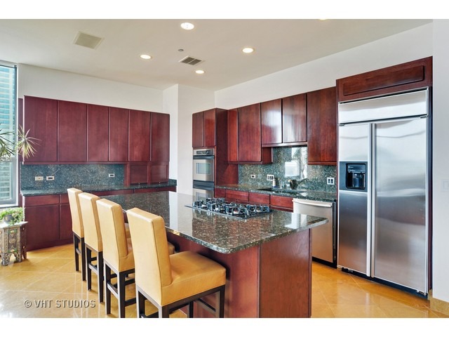 910 South Michigan Avenue, Unit 1101 Chicago, IL 60605 - Photo 5 of 20 a kitchen with stainless steel appliances granite countertop a stove refrigerator and cabinets
