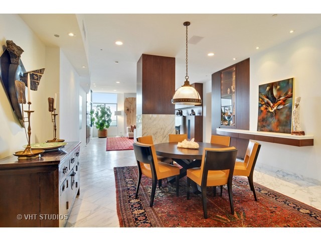 910 South Michigan Avenue, Unit 1101 Chicago, IL 60605 - Photo 7 of 20 a view of a dining room with furniture and a flat screen tv