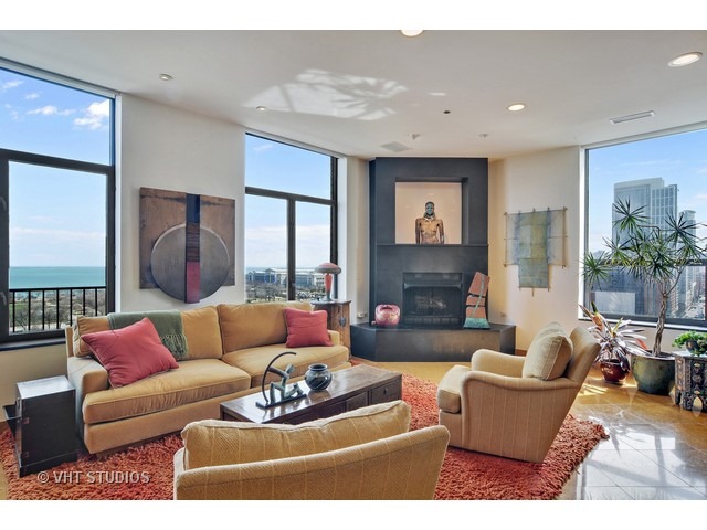 910 South Michigan Avenue, Unit 1101 Chicago, IL 60605 - Photo 9 of 20 a living room with furniture and a fireplace