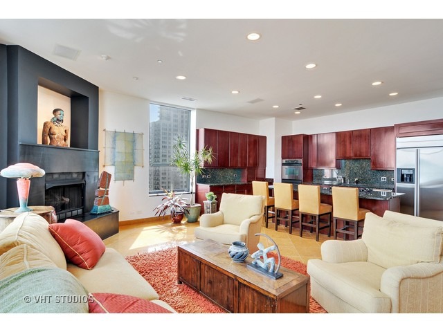 910 South Michigan Avenue, Unit 1101 Chicago, IL 60605 - Photo 10 of 20 a living room with fireplace furniture and a fireplace