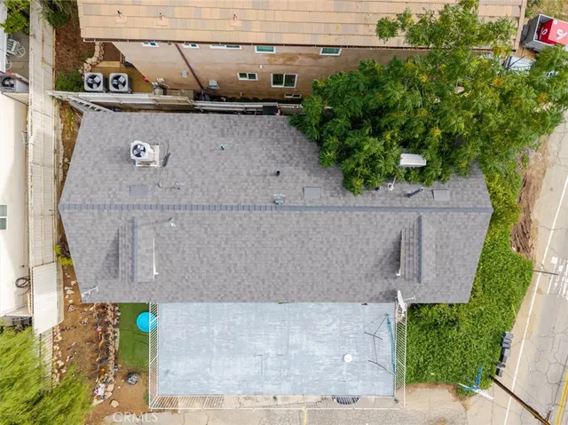 an aerial view of a house with a yard and garden