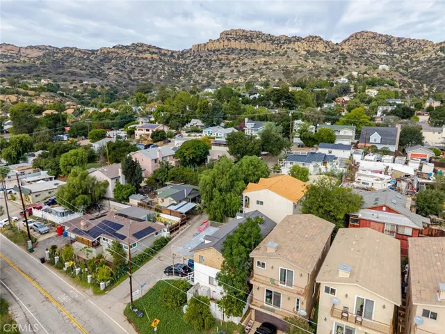 an aerial view of residential houses with city view